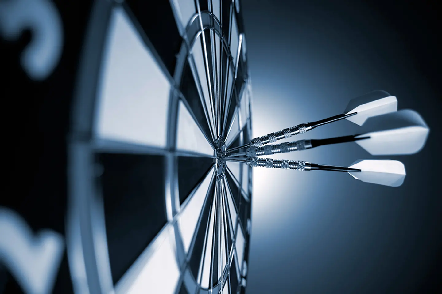 A dart board with darts at the center