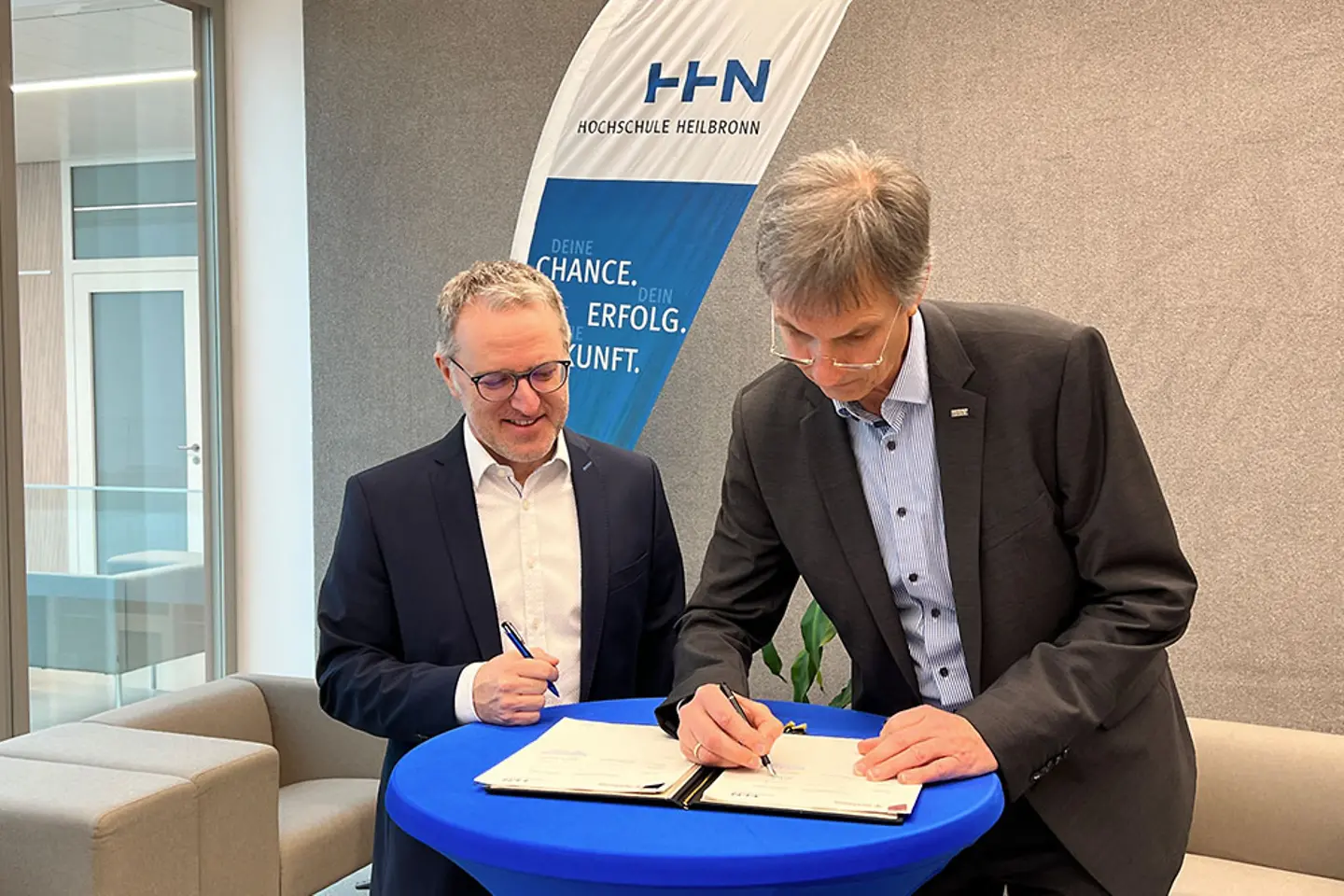 2 men signing a document