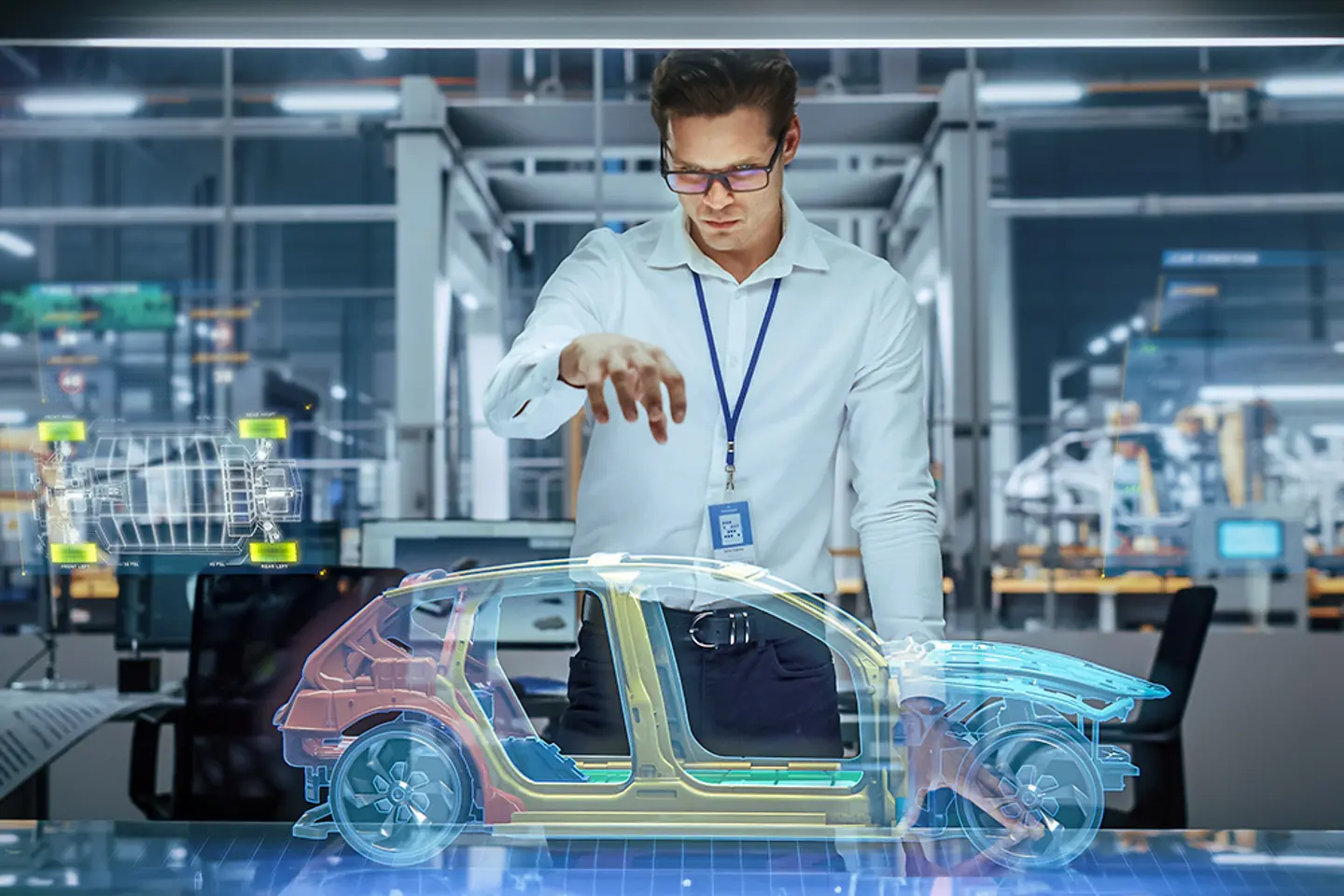 An automotive engineer using Augmented Reality to construct a 3D Hologram Model of an electric car.