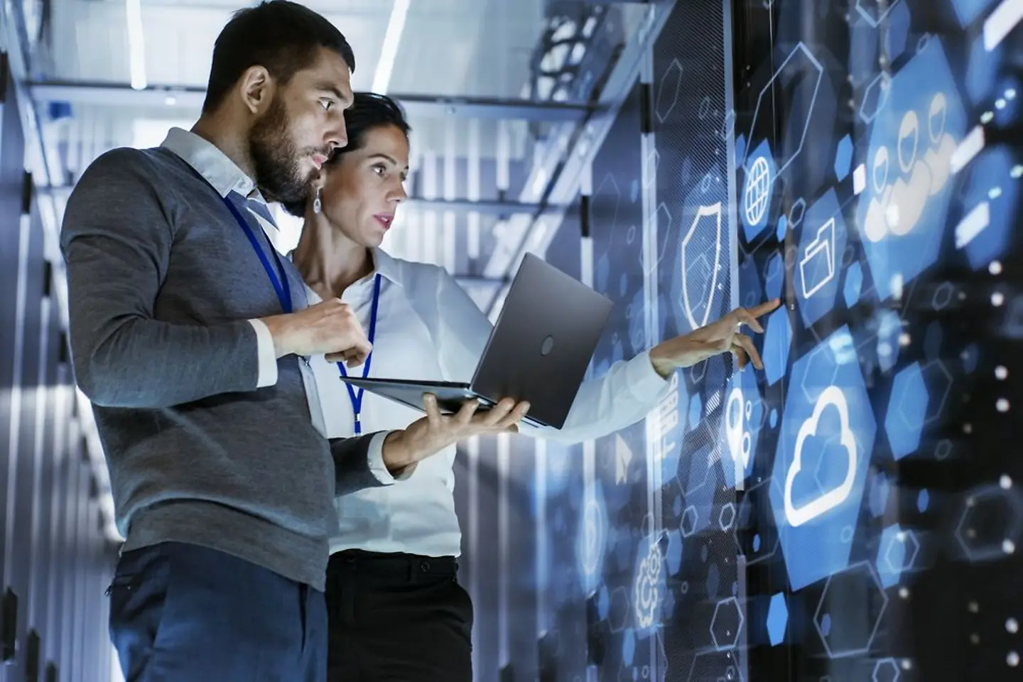 Two software professionals working in a data server room