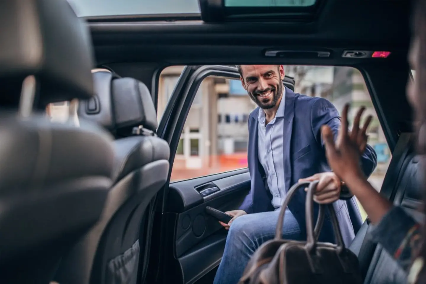Businessman enters a car