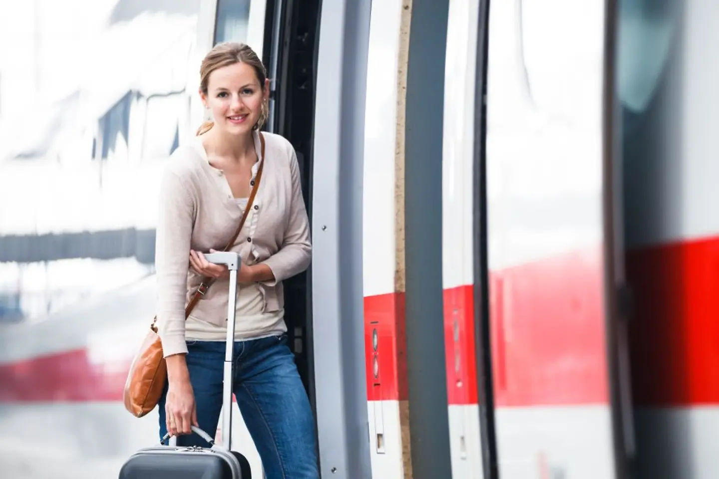 Women with her luggage boarding a Deutsche Bahn train