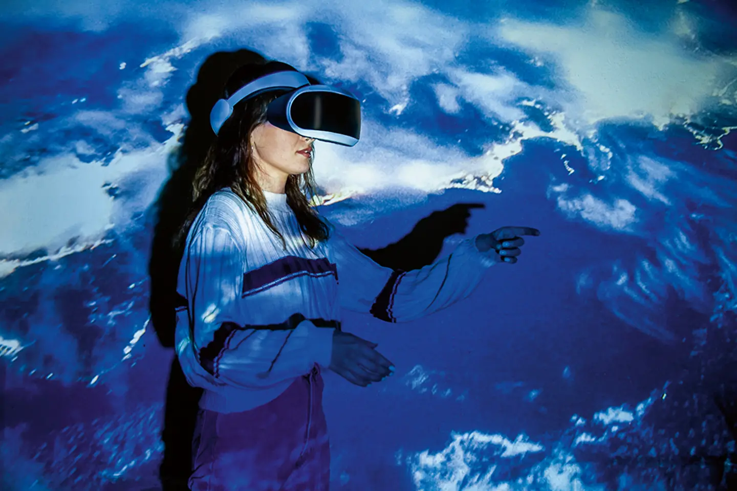 Woman exploring virtual reality against blue background
