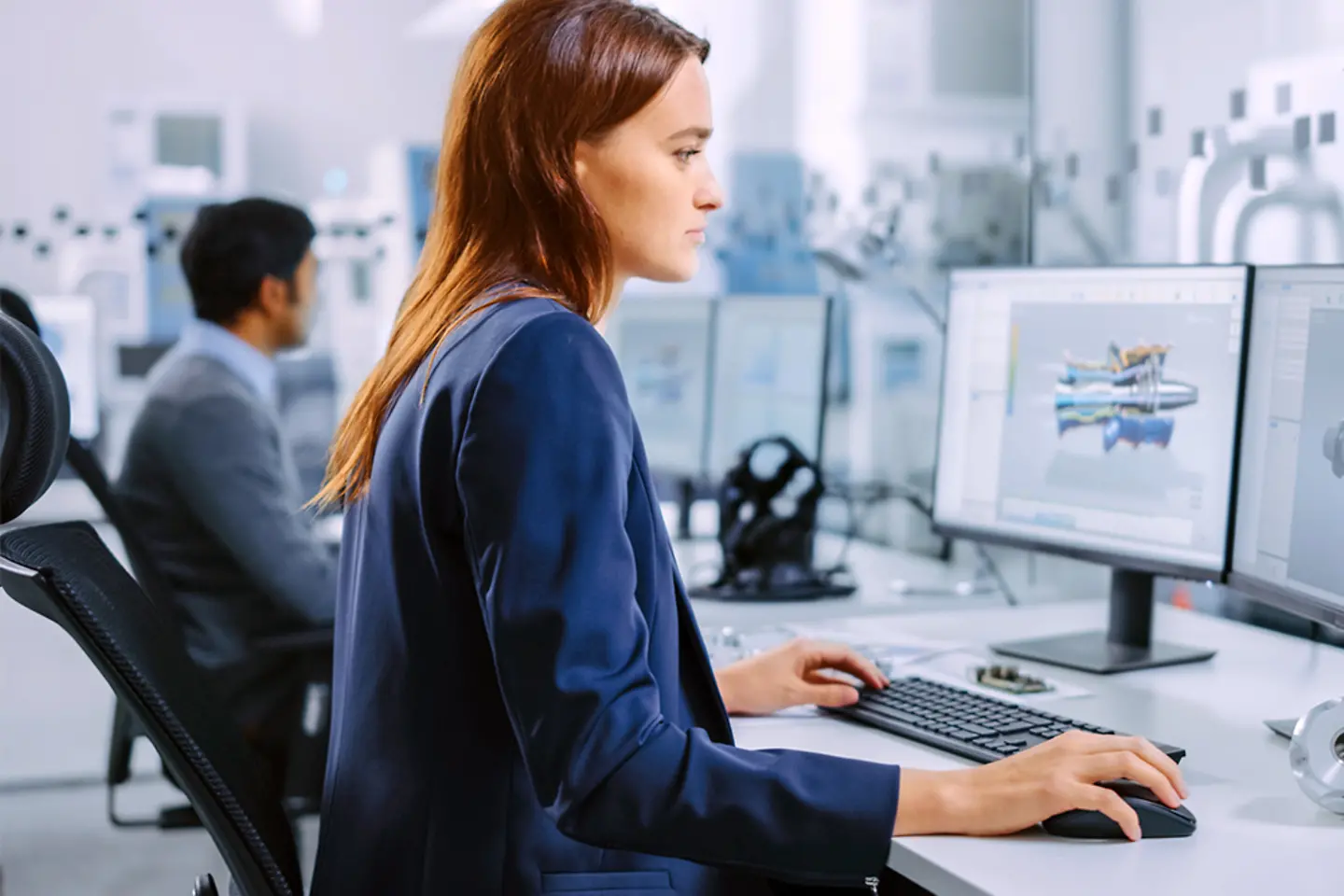Female mechanical engineer working on a prototype on computer