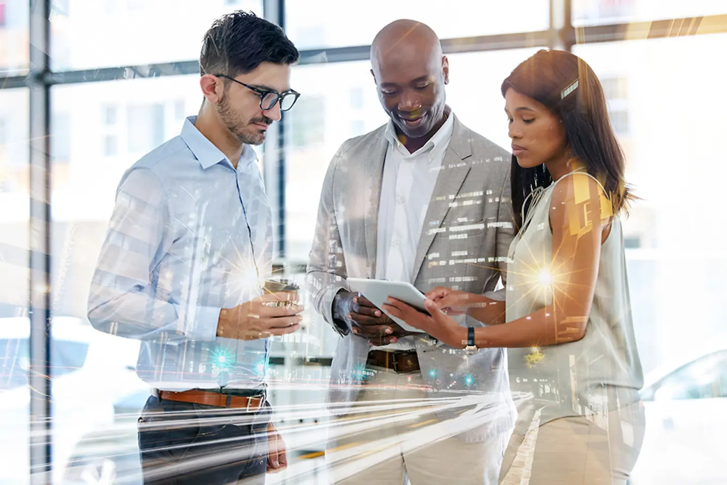 Employees looking at a tablet in an office setting