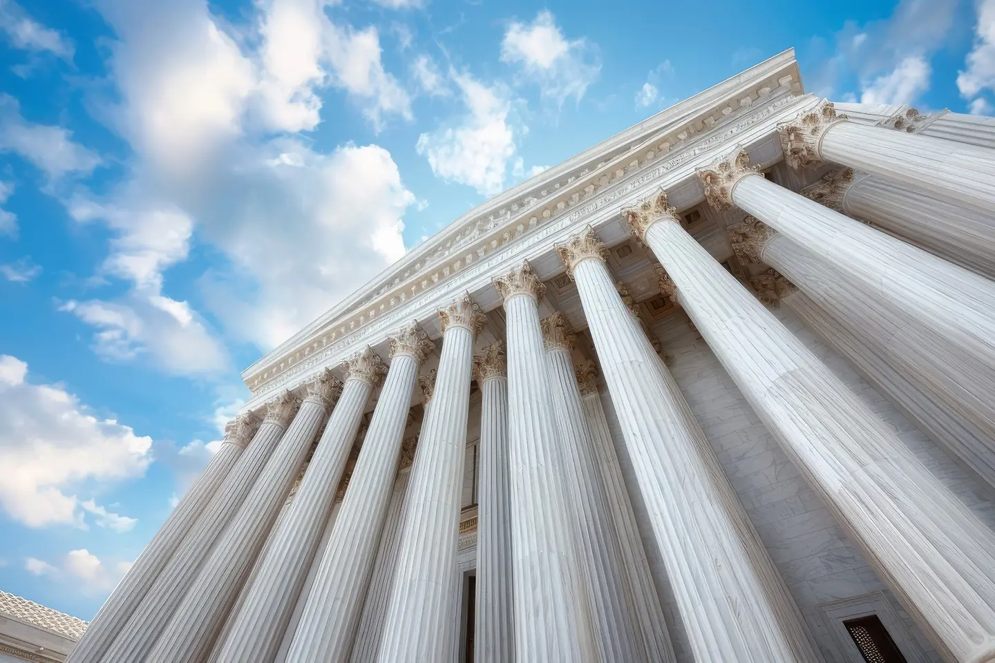 Imposing government building with silhouette against blue sky and clouds