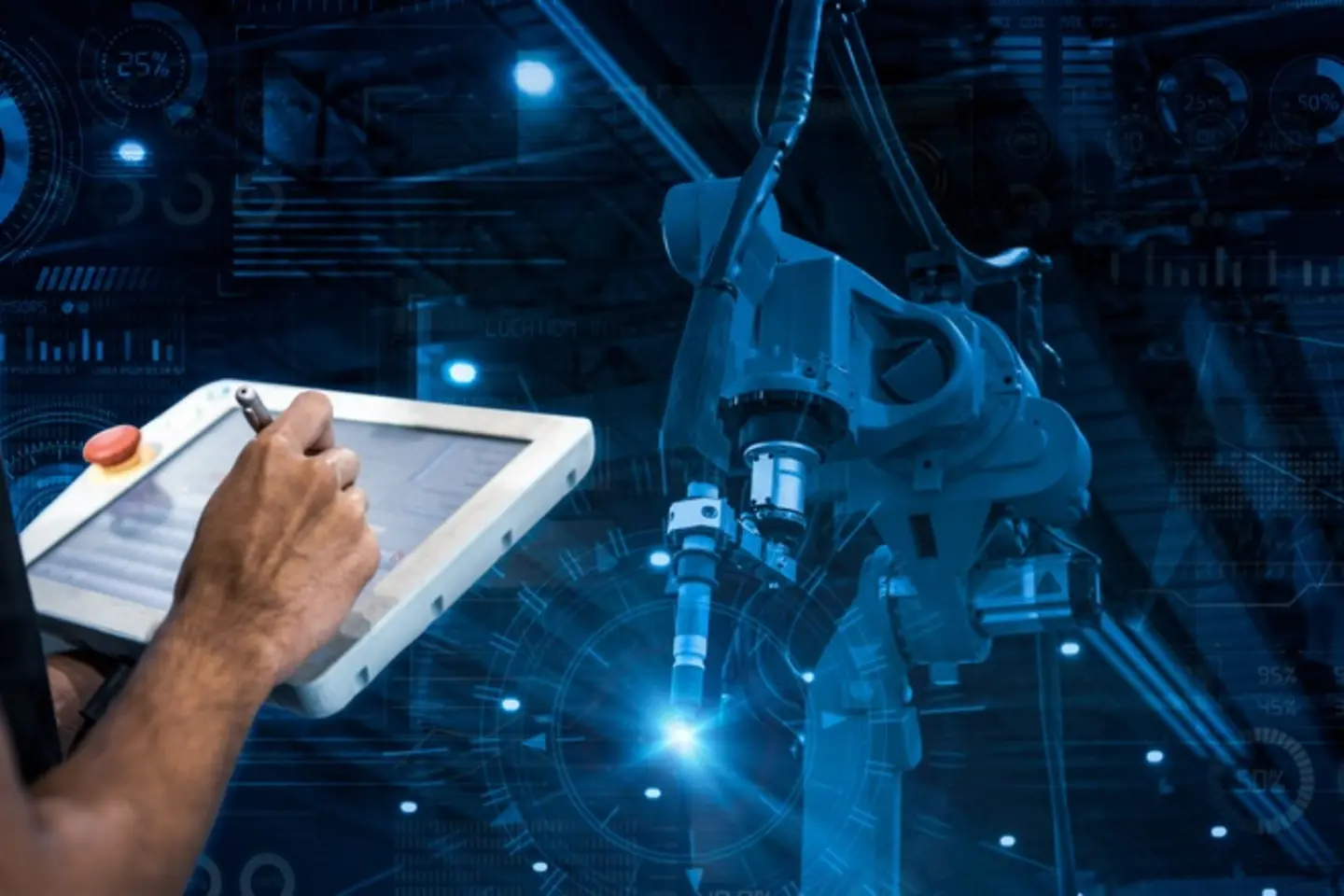 Person with tablet and pen stands in front of robot-like machine.