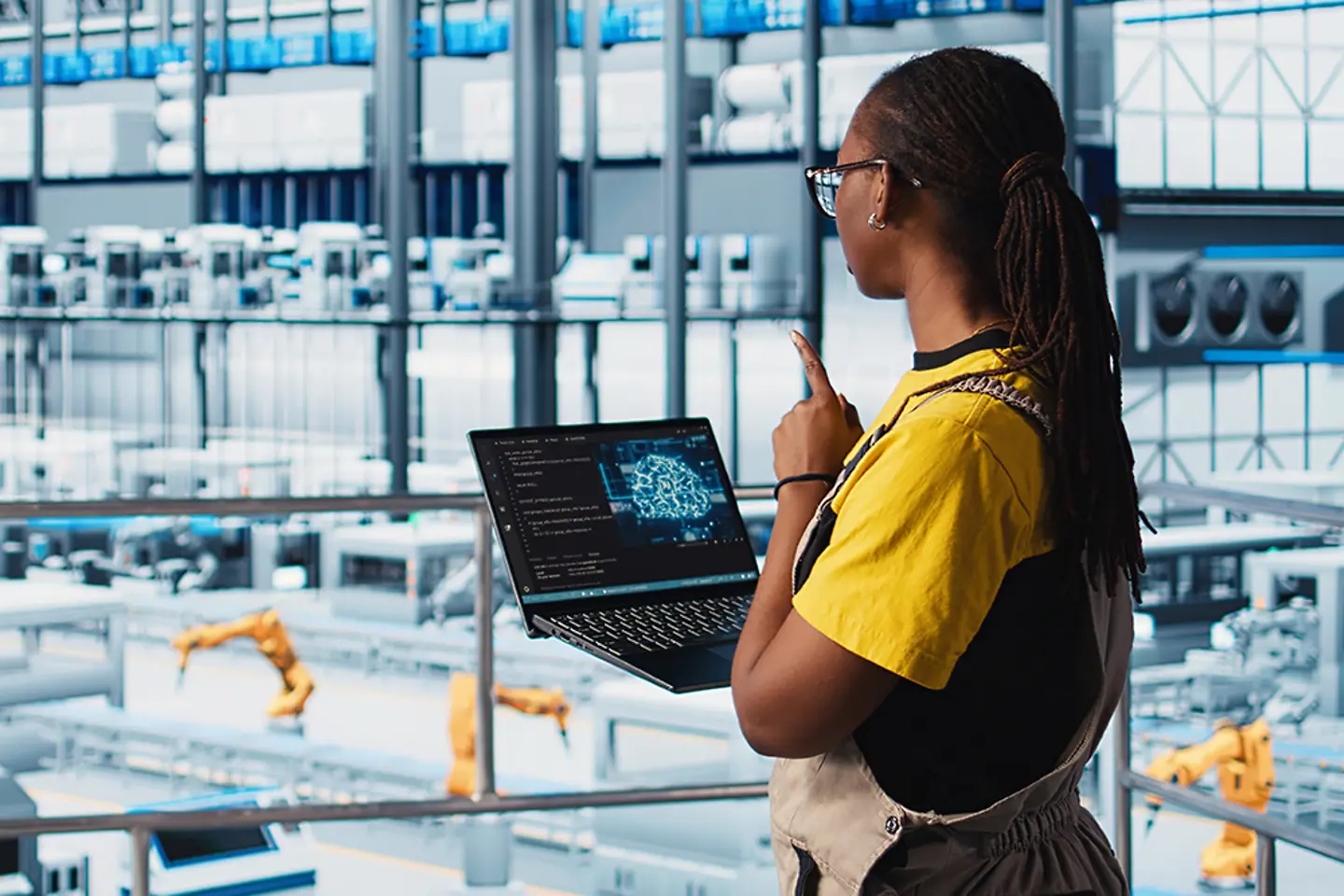 Engineer in smart factory uses augmented reality to collect data on laptop.