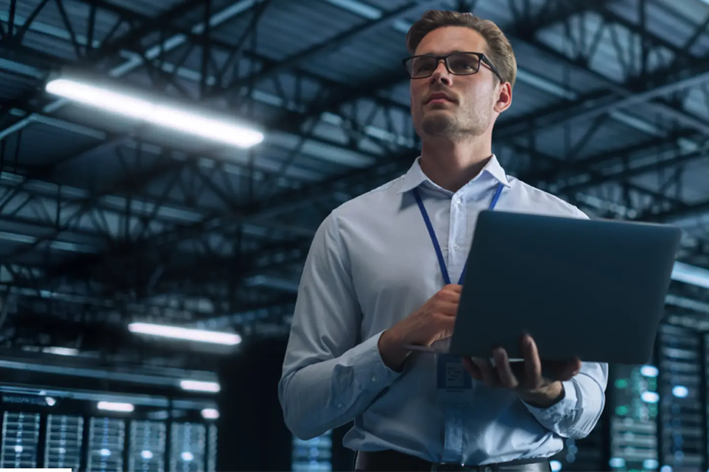 IT specialist using laptop in data center