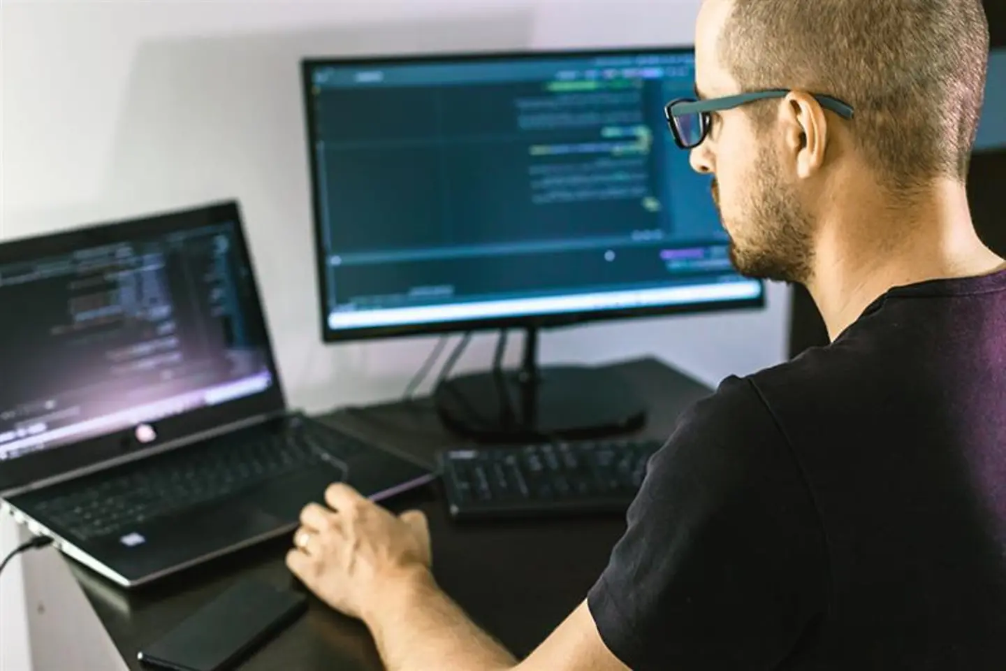A computer programmer working on a laptop