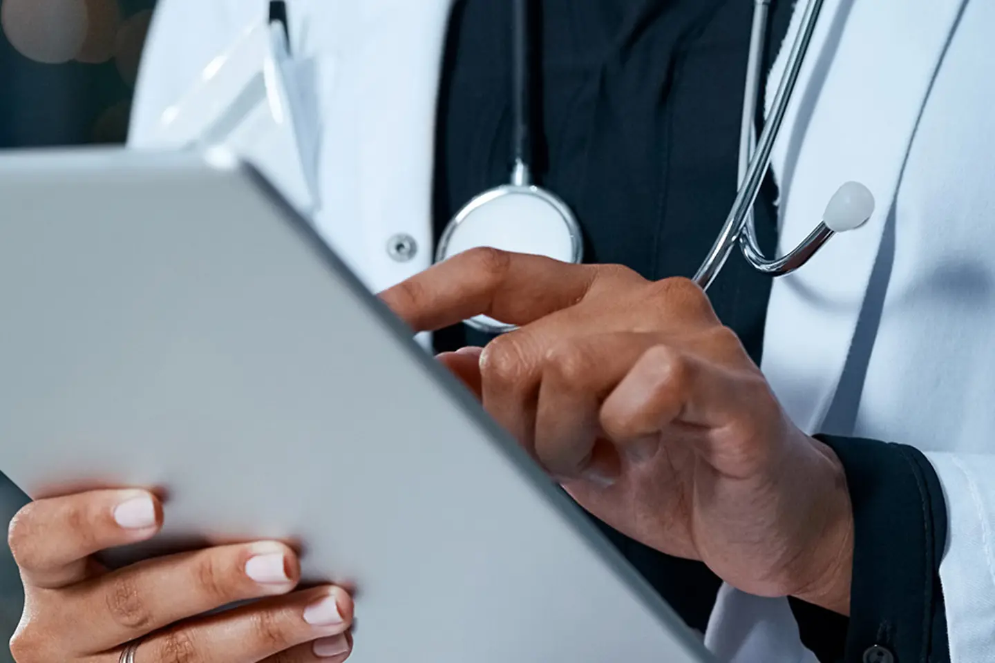 A doctor holds a tablet in her hand.