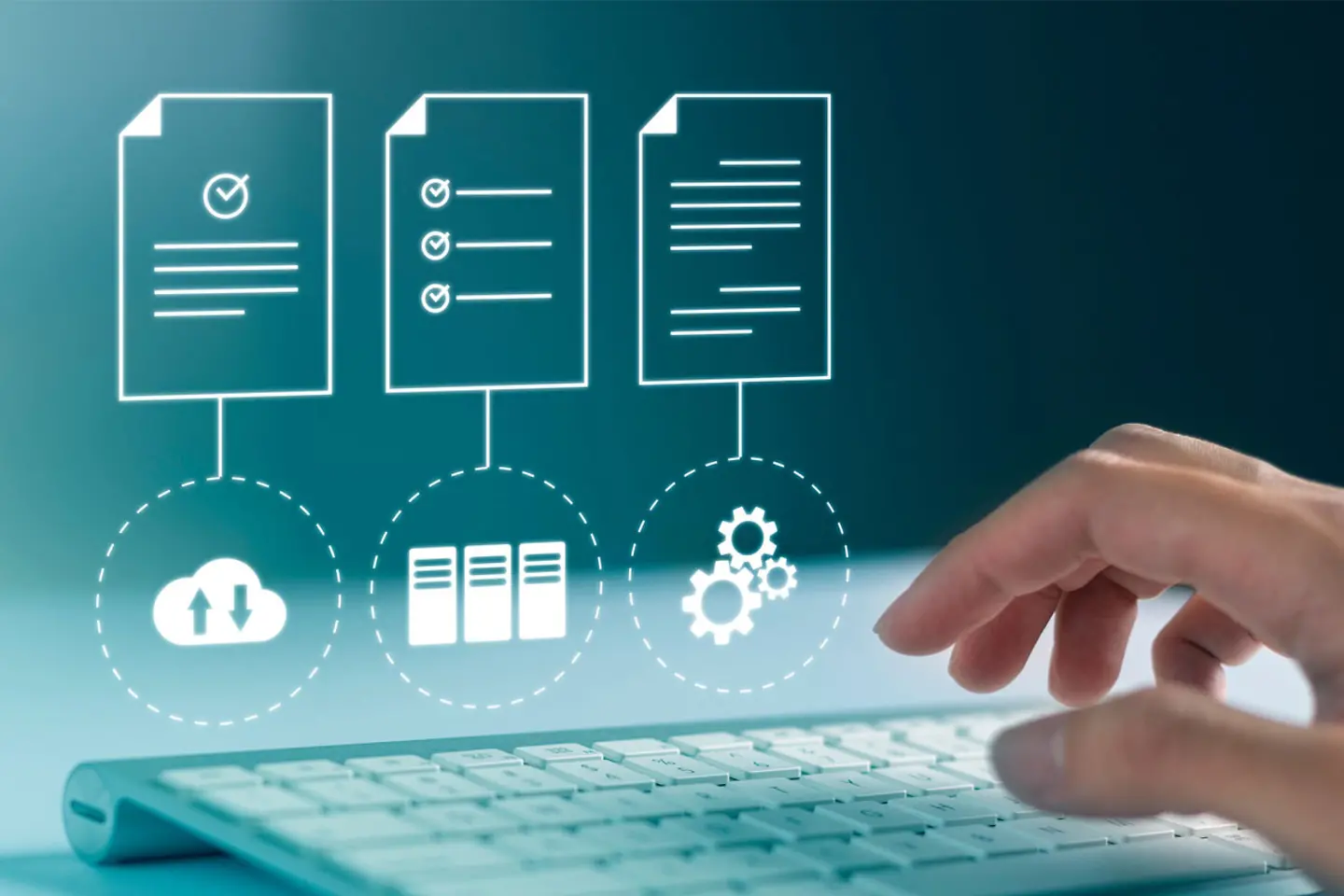 A hand typing into keyboard and computer with cloud access