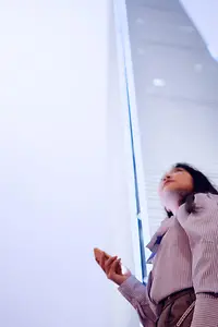 Kundin nutzt die Cloud auf ihrem Mobiltelefon vor einem Gebäude