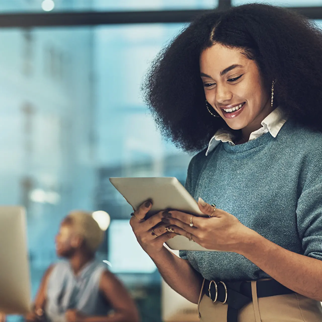 Business woman in office looking at a tablet