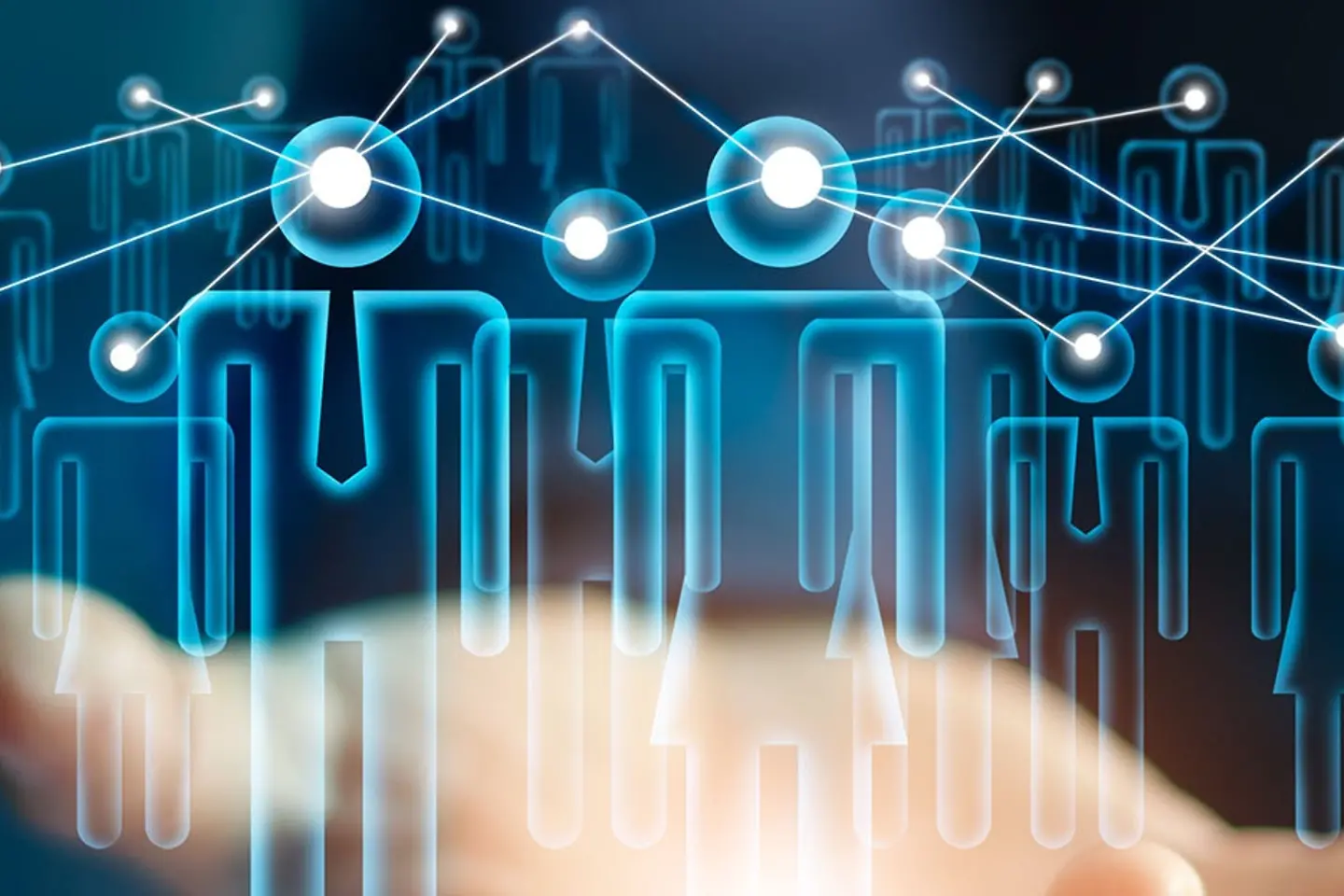 A virtual representation of interconnected people hovers above an outstretched hand.