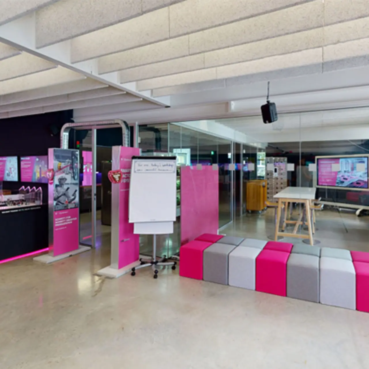 Innovation Center workshop room with colored chairs separated by a glass wall